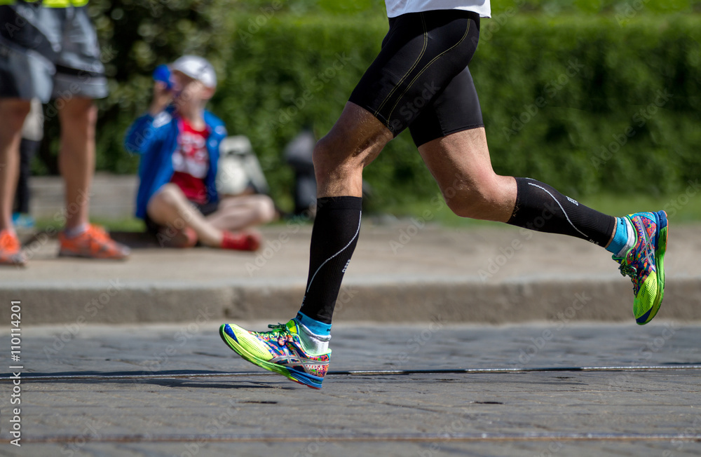 Jogging close up of sport fitness running shoes and legs and shorts. Jogging close up of sport fitness running shoes and legs and shorts.
