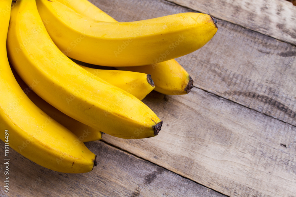 yellow bananas on wooden background yellow bananas on wooden background