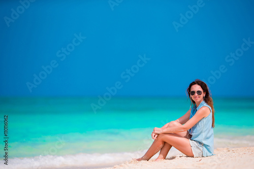 Young beautiful woman enjoying the music on the beach