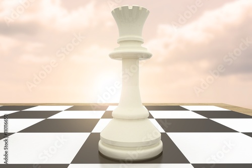 Composite image of white queen on chess board