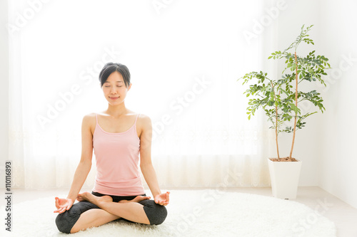 attractive asian woman exercising in the room © taka