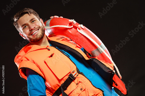 Lifeguard in life vest with ring buoy lifebuoy.