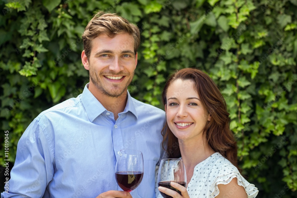 Happy couple holding wineglasses at front yard Happy couple holding wineglasses at front yard