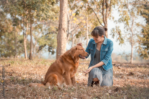 Beautiful woman with a cute golden retriever dog © wittybear