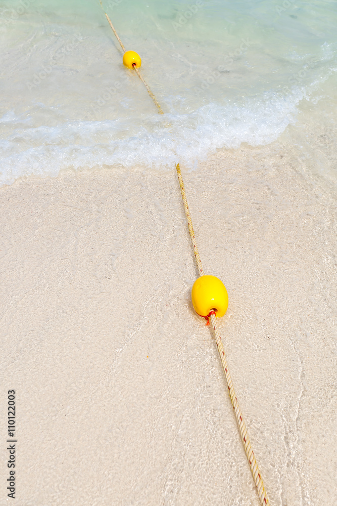 Naklejka premium Yellow buoy on the beach