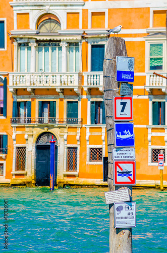 a giant cruise ship full of passengers is leaving italian city venice after busy touristic day. photo