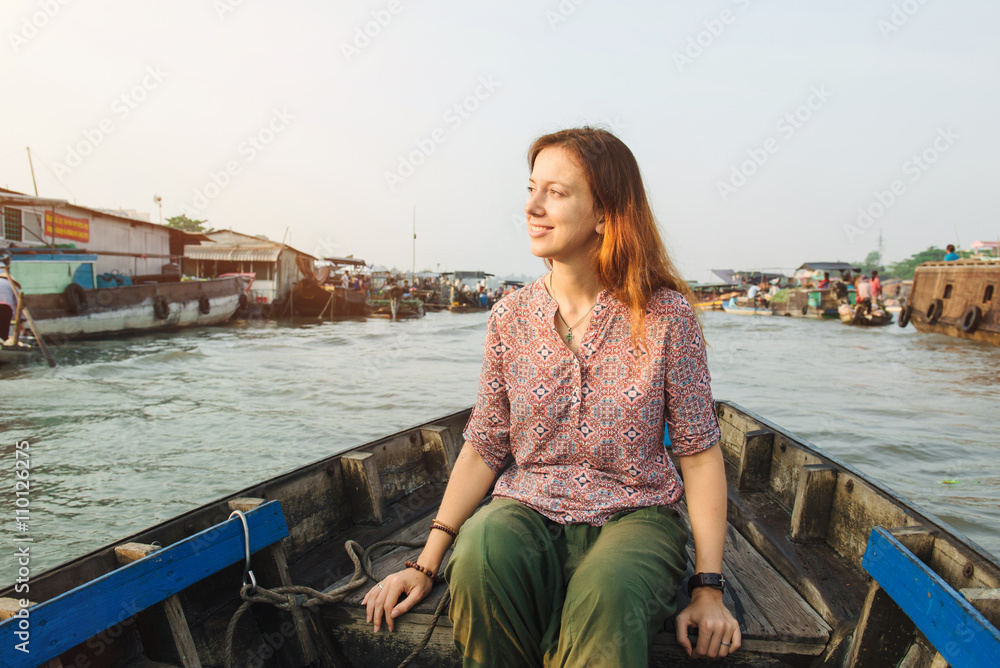 Woman tourist on floating market in Vietnam Woman tourist on floating market in Vietnam