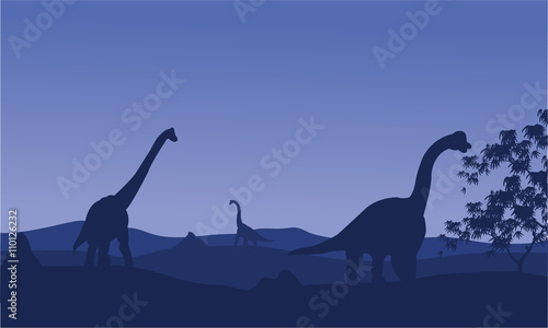 Silhouette of brachiosaurus with blue backgrounds