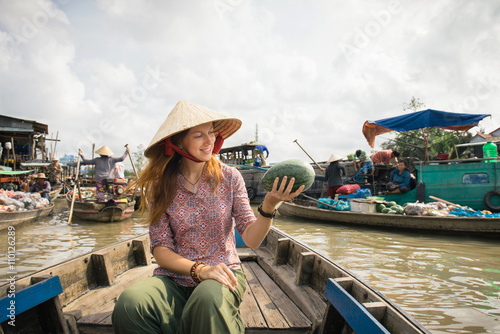 Woman tourist on floating market in Vietnam © gilitukha