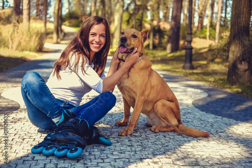 Attractive brunette female posing with her dog.