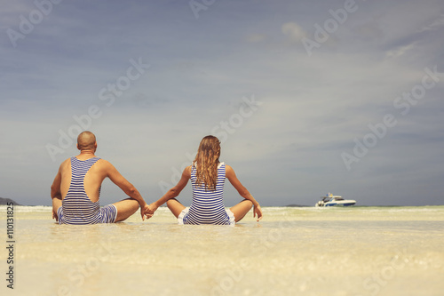 Beautiful happy couple in retro swimsuit relaxing and enjoy on the beach