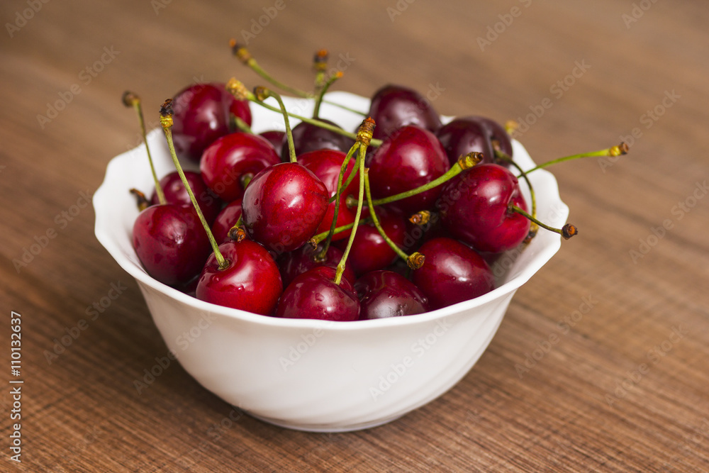 Cherries on wooden table with water drops macro background Cherries on wooden table with water drops macro background