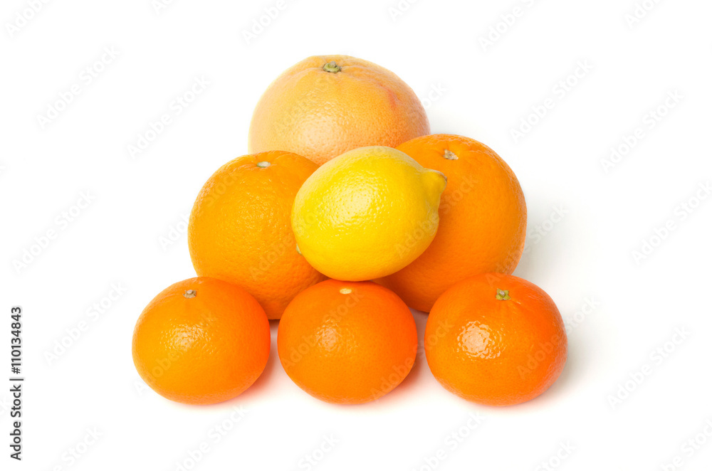 A heap of mixed citrus fruit including lemon, grapefruit, oranges and mandarines isolated on a white background A heap of mixed citrus fruit including lemon, grapefruit, oranges and mandarines isolated on a white background