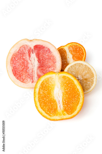 Halfes of grapefruit, orange, lemon and mandarin isolated on white