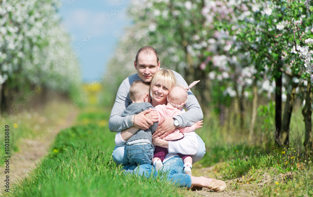 Family among the blossoming apple-trees. Family among the blossoming apple-trees.
