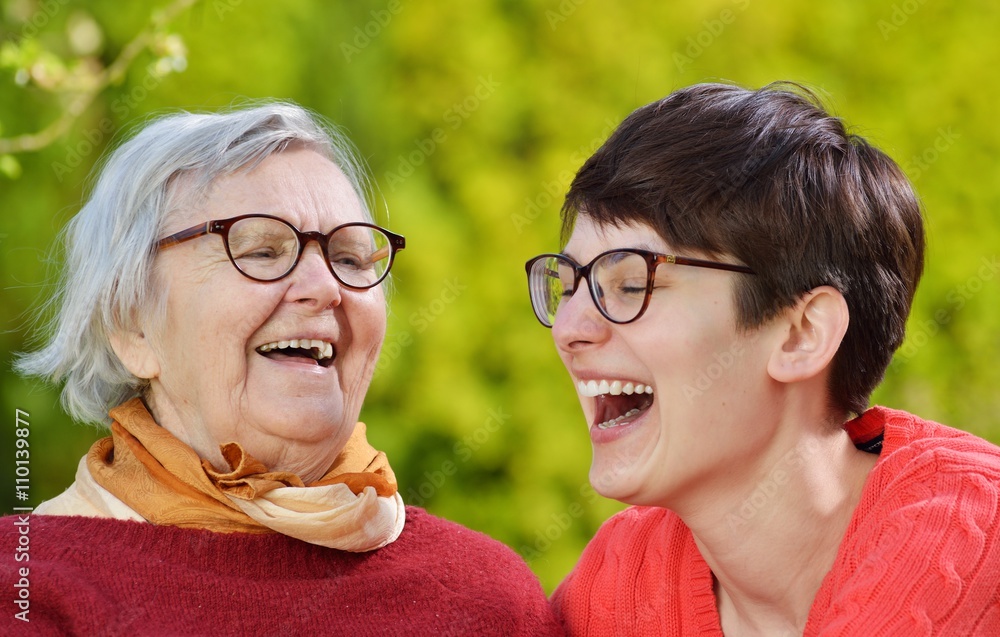 Grandmother and granddaughter. Young woman carefully takes care