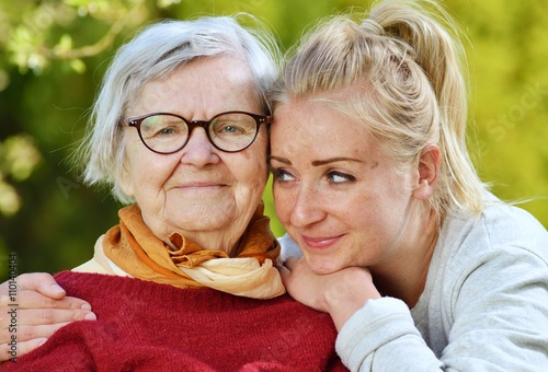 Obraz na płótnie Grandmother and granddaughter. Young woman carefully takes care w salonie