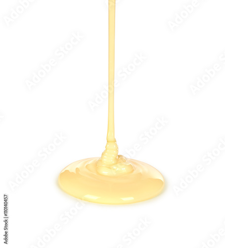 pouring condensed milk isolated on a white background photo