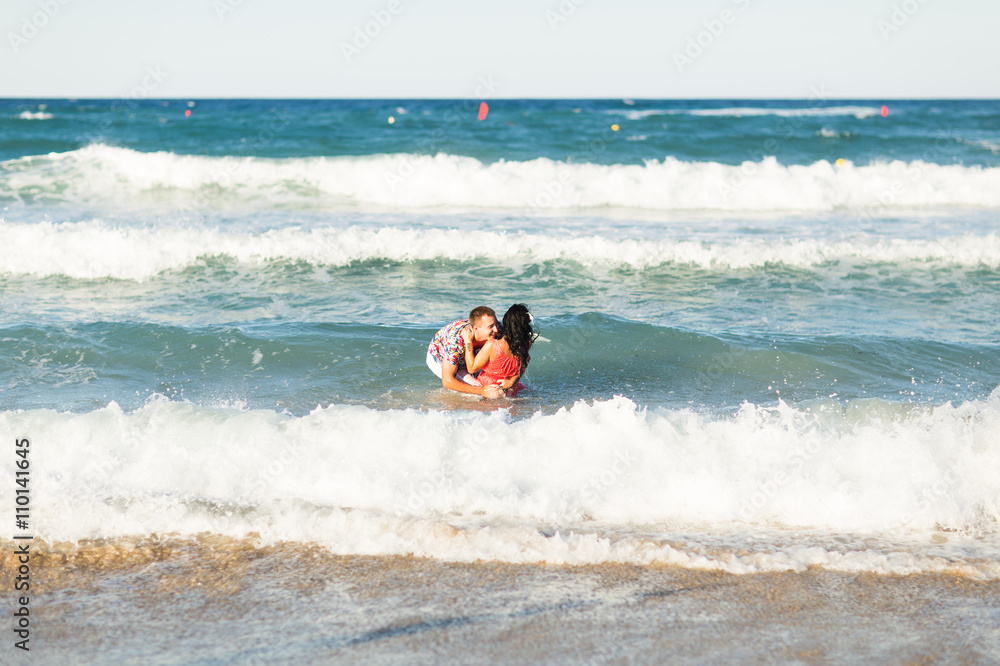 Beautiful young couple in love enjoying and having fun at the beach Beautiful young couple in love enjoying and having fun at the beach