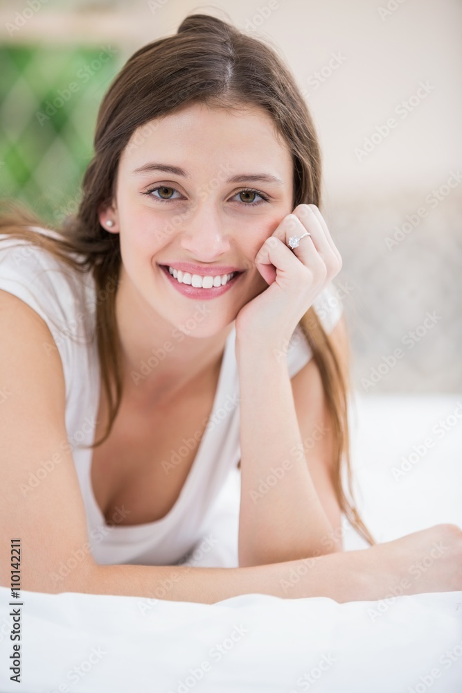 Portrait of smiling woman lying on bed Portrait of smiling woman lying on bed