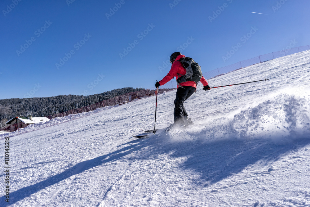 Action shot of female skier on italian slopes.