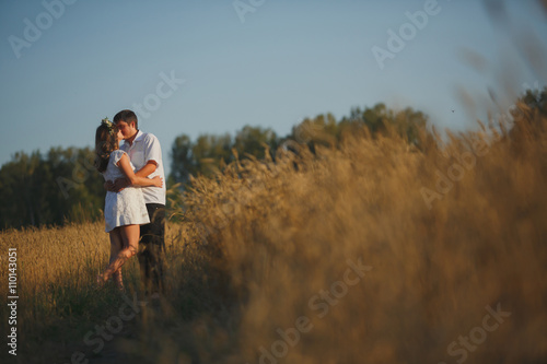 romantic happy couple go on a wheat field. © Diflope