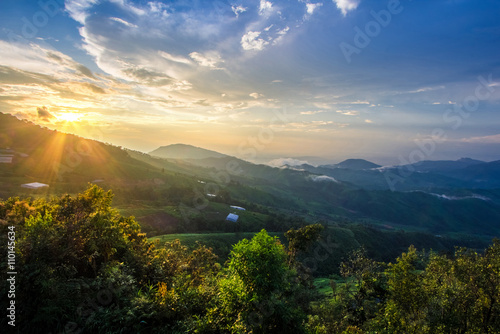 light burst at tropical rain forest and mountain landscape © happystock
