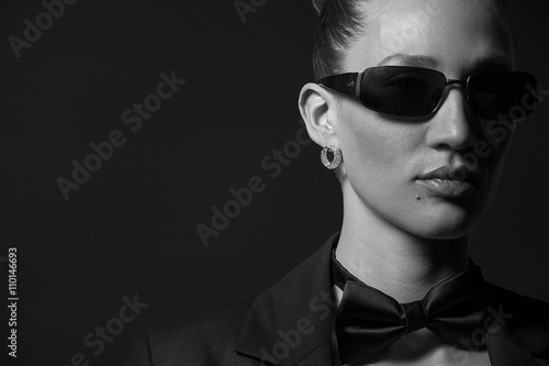 Portrait of Beautiful young woman in sunglasses with butterfly.M