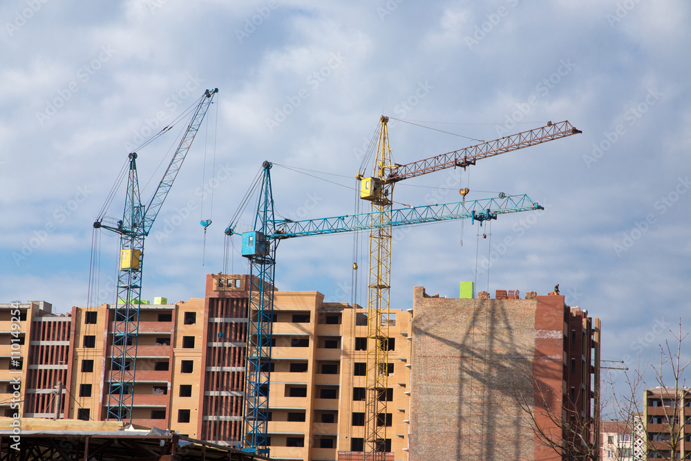 Construction site with cranes on sky background Construction site with cranes on sky background