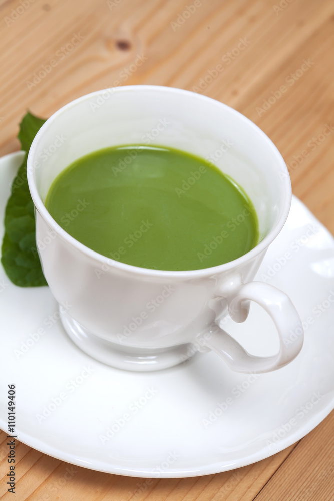 green tea with milk or hot matcha latte on wood green tea with milk or hot matcha latte on wood