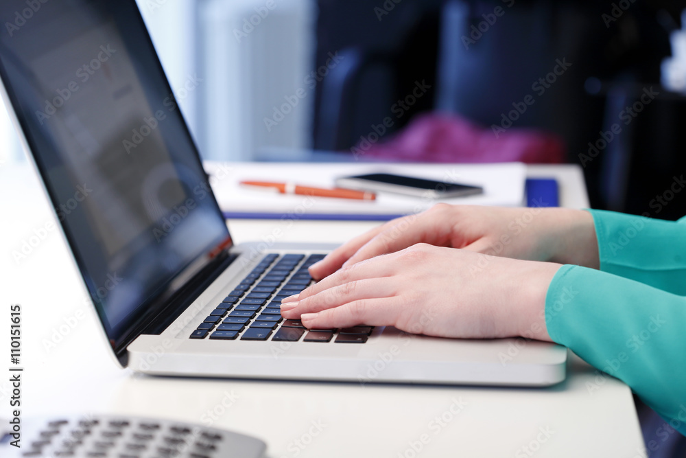 Hands typing on laptop computer Hands typing on laptop computer