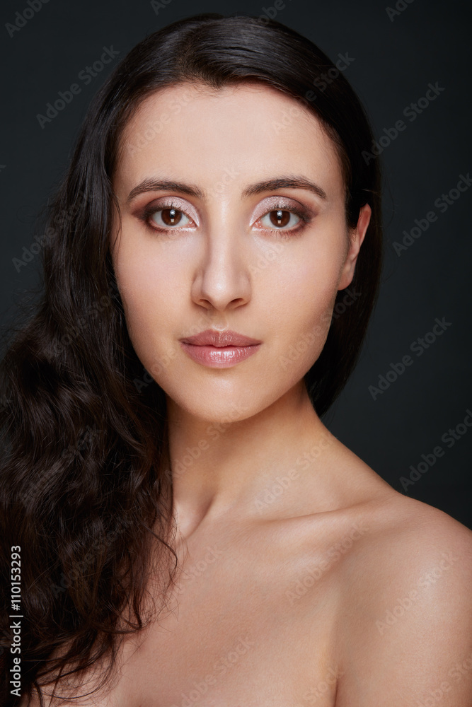 Young woman beauty face with natural colors make up, long dark h Young woman beauty face with natural colors make up, long dark h