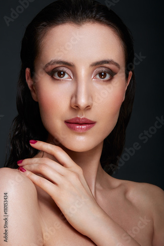 Woman beauty face with shiny eye shadow make up and hand with pi
