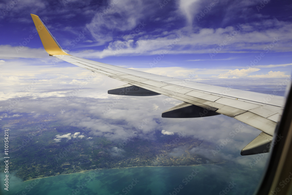 View from airplane window. Wing of an airplane flying above the View from airplane window. Wing of an airplane flying above the