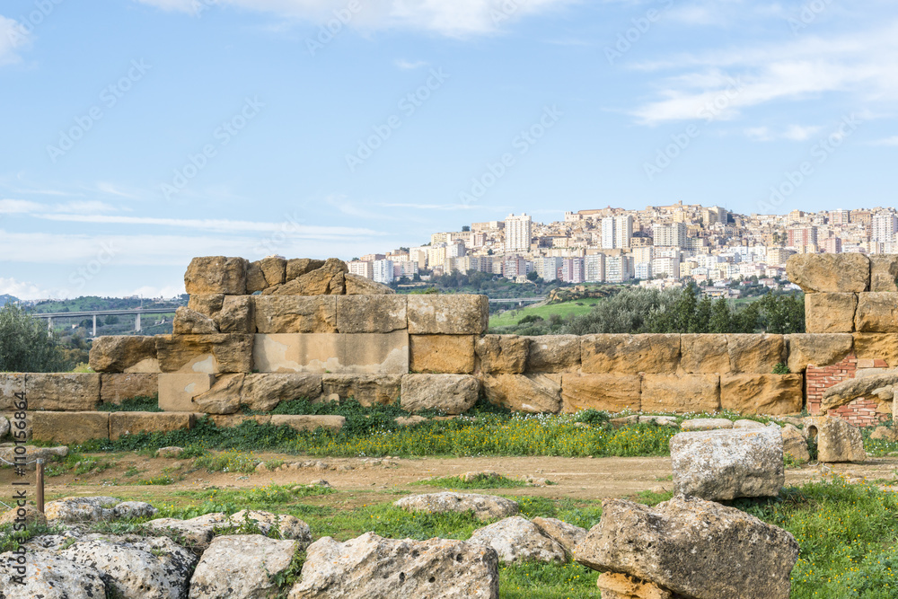Ancient ruins and  Agrigento city  in the background. Sicily. Italy.