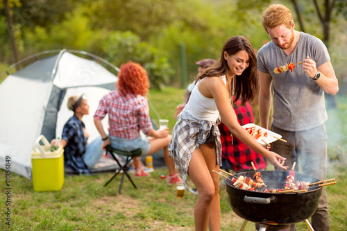 Young brunette with boyfriend serving on plate barbecue