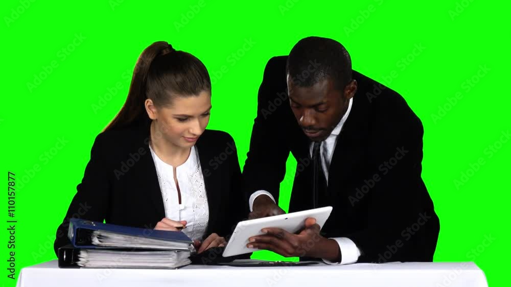Two businessman discussing documents on laptop. Green screen Two businessman discussing documents on laptop. Green screen