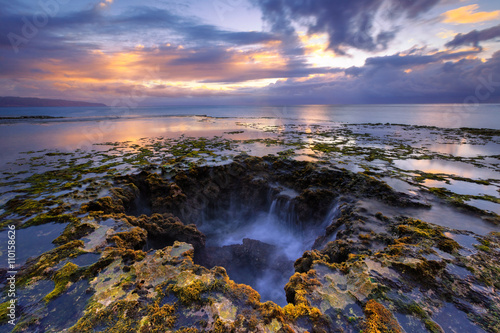 Sunset at low tide volcanic coast. Seascape of North shore Oahu, Hawaii island. 