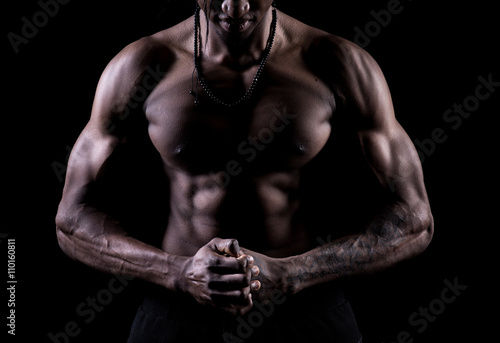 Studio shot of muscular afro-american man posing with black background