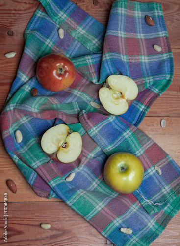 apples on a napkin on a wooden table
