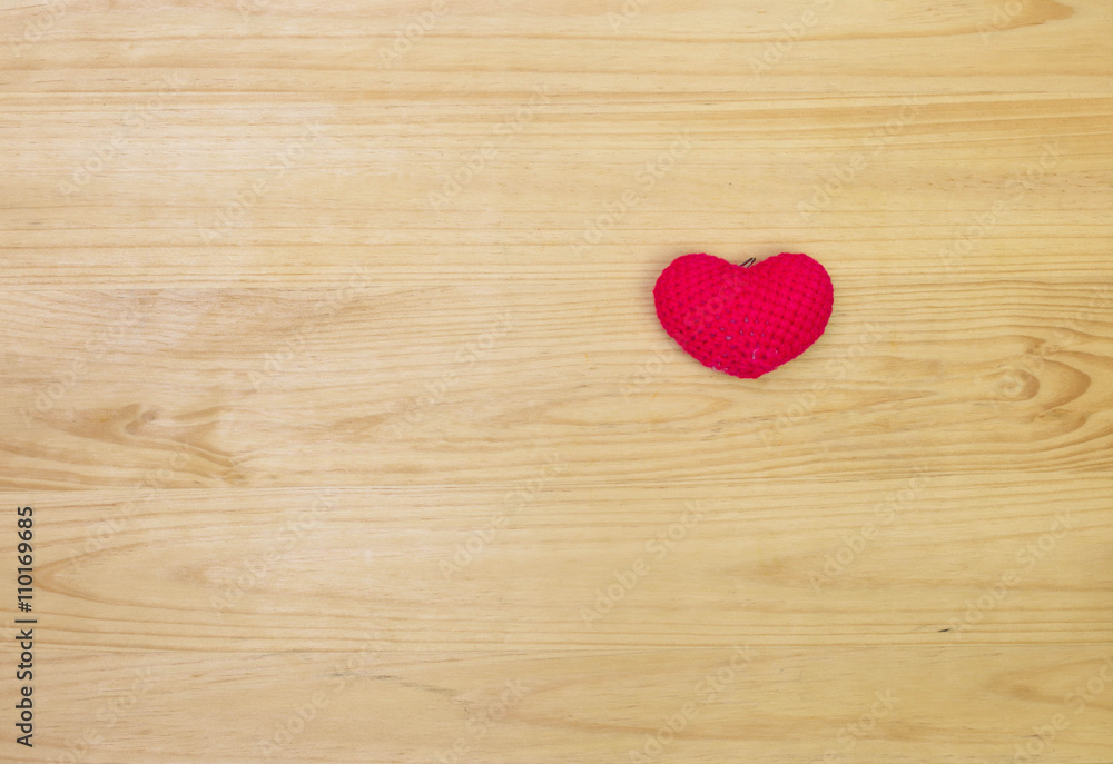 Red wool heart shape on wooden background Red wool heart shape on wooden background