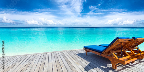 sun lounger bed on jetty in front of paradise ocean beach / Sonnenliege auf Steg vor türkis farbenen Meer Paradies mit Traumstrand  © stockphoto-graf