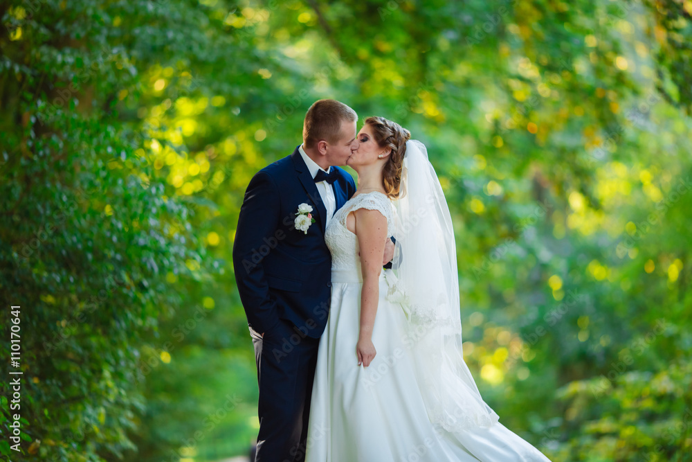 Bride and groom on the background of green park Bride and groom on the background of green park