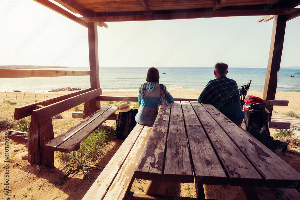 Couple of travelers on wooden veranda