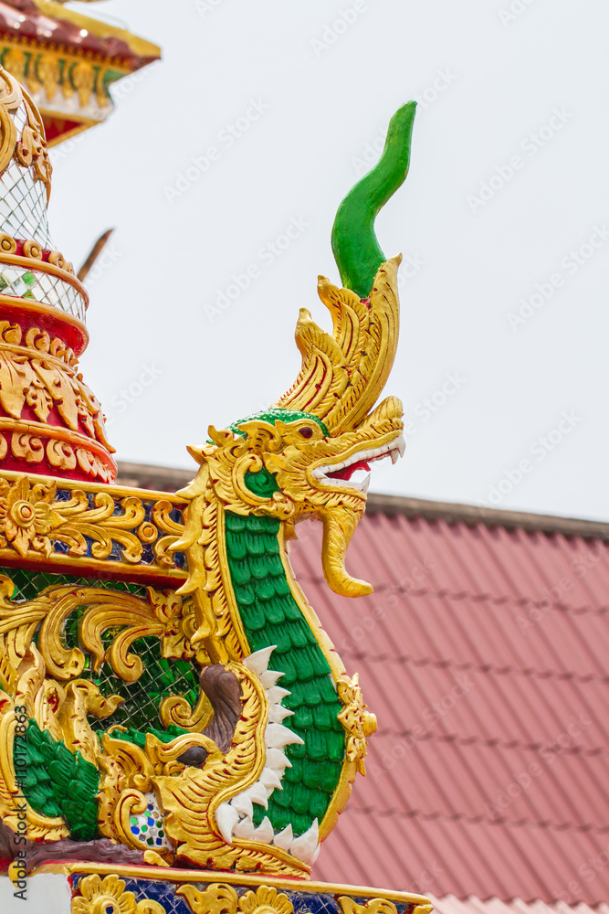 Fototapeta premium Traditional Thai style naga art on the roof in temple