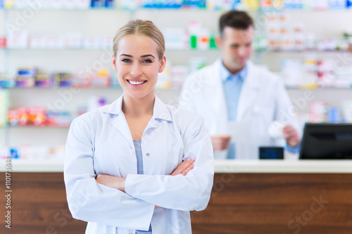 Female and male pharmacists in pharmacy 