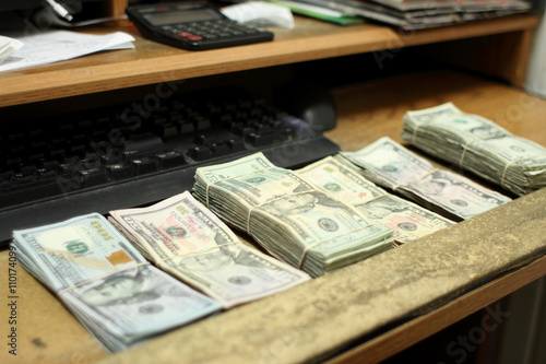 Counting cash in a small retail business office.