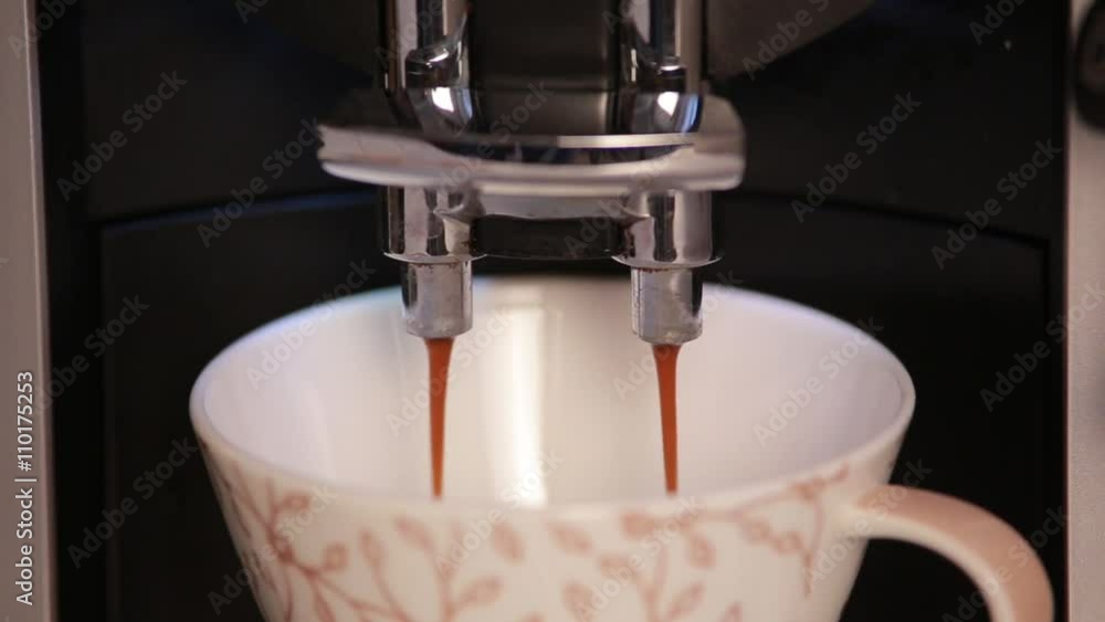 Coffee maker fills ceramic cup of coffee. Coffee maker fills ceramic cup of coffee.