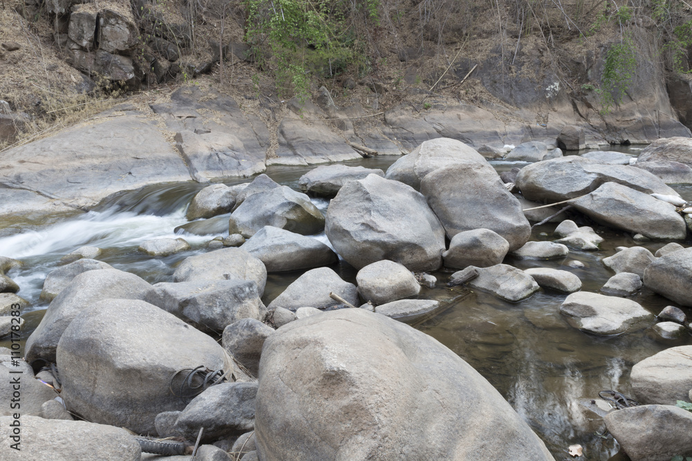 water stream through stone in creek water stream through stone in creek
