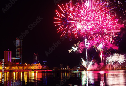 fireworks over the night city and city pond Yekaterinburg city center. Celebrating the victory of May 9, 2016